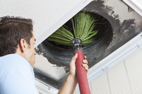 Man performing air duct cleaning services